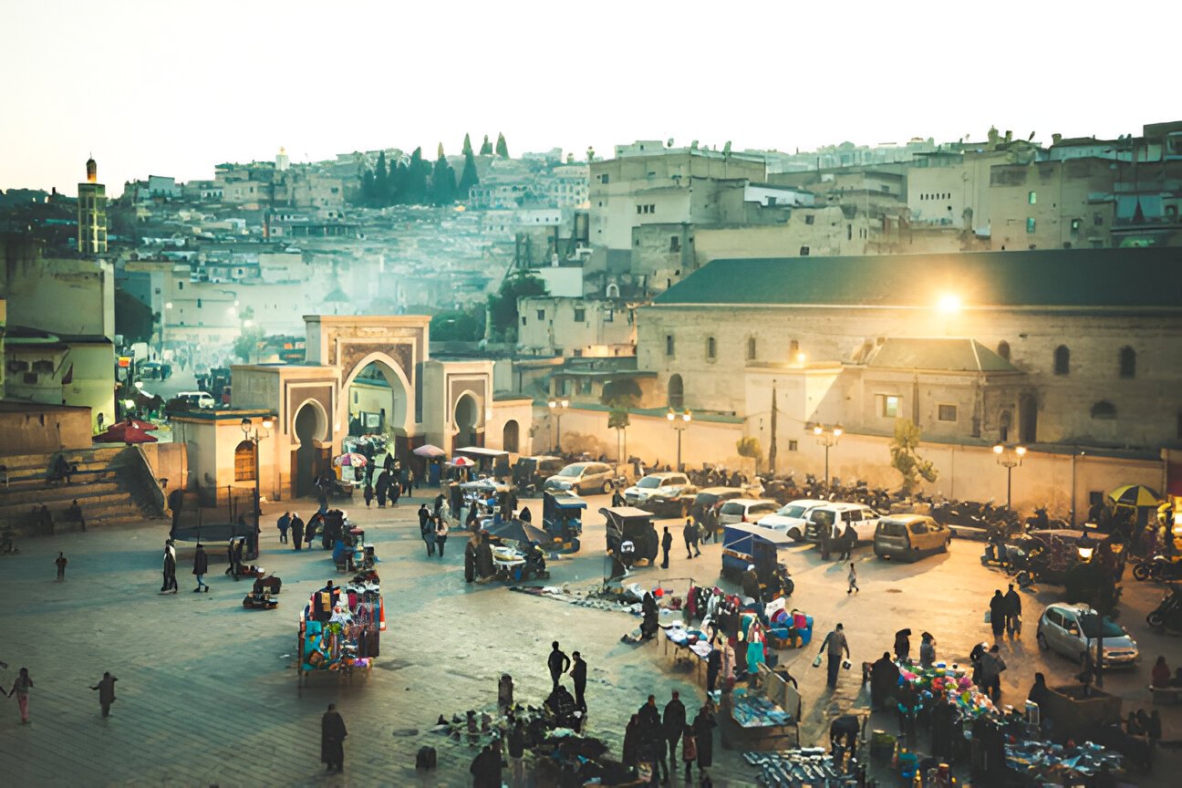 Local life in a Fes medina square at sunset